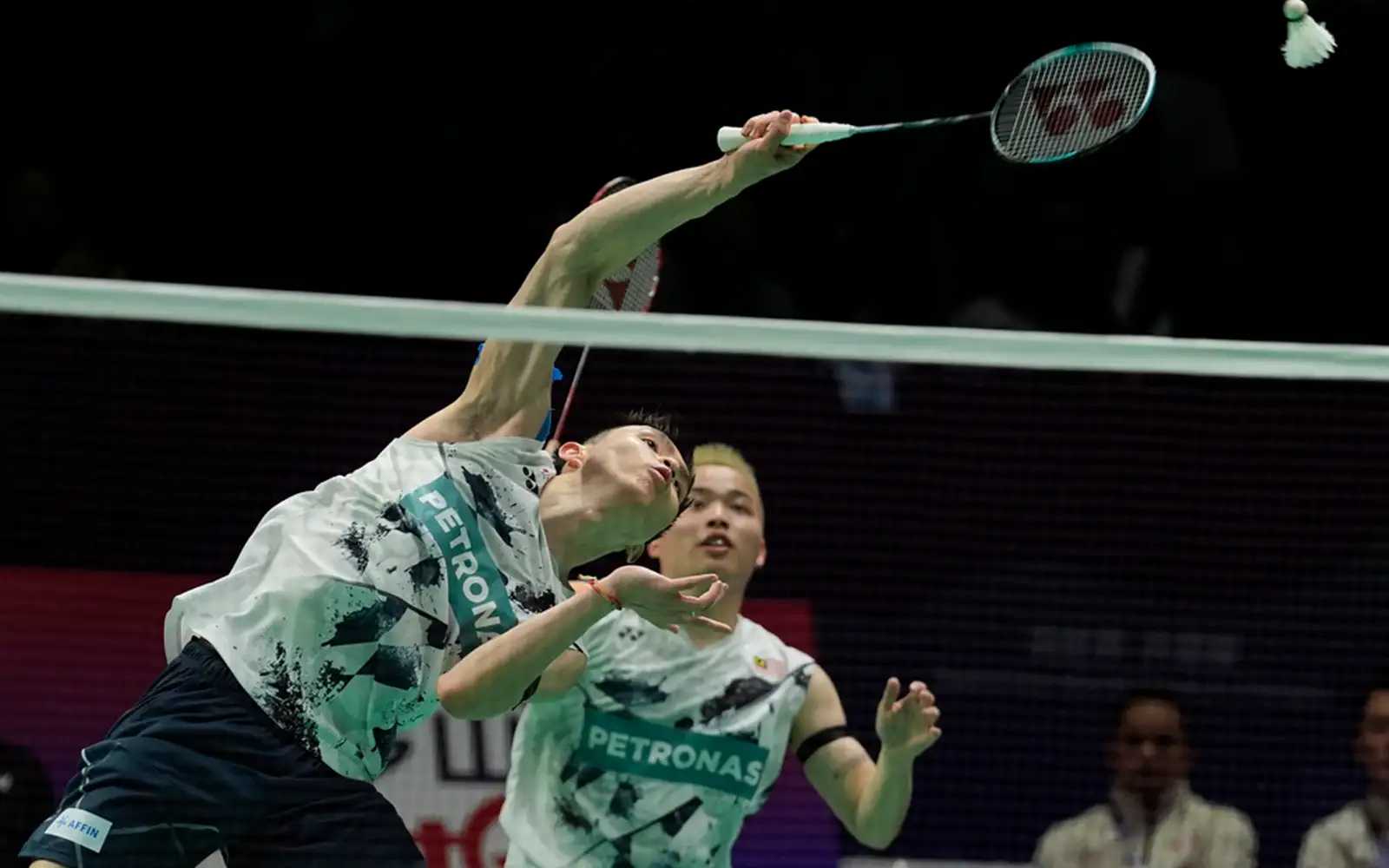 Malaysia's Soh Wooi Yik returns a shot near Aaron Chia, right against Denmark's Kim Astrup and Anders Skaarup Rasmussen in a round 3 match for the Thomas Cup Finals held in Chengdu in southwestern China's Sichuan Province, Tuesday, April 30, 2024. (AP Photo/Ng Han Guan)